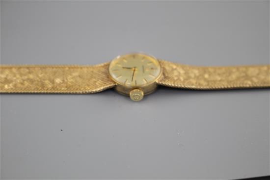 A ladys 1960s? 9ct gold Omega manual wind wristwatch, on integral textured 9ct gold Omega bracelet, gross weight 23.2 grams.